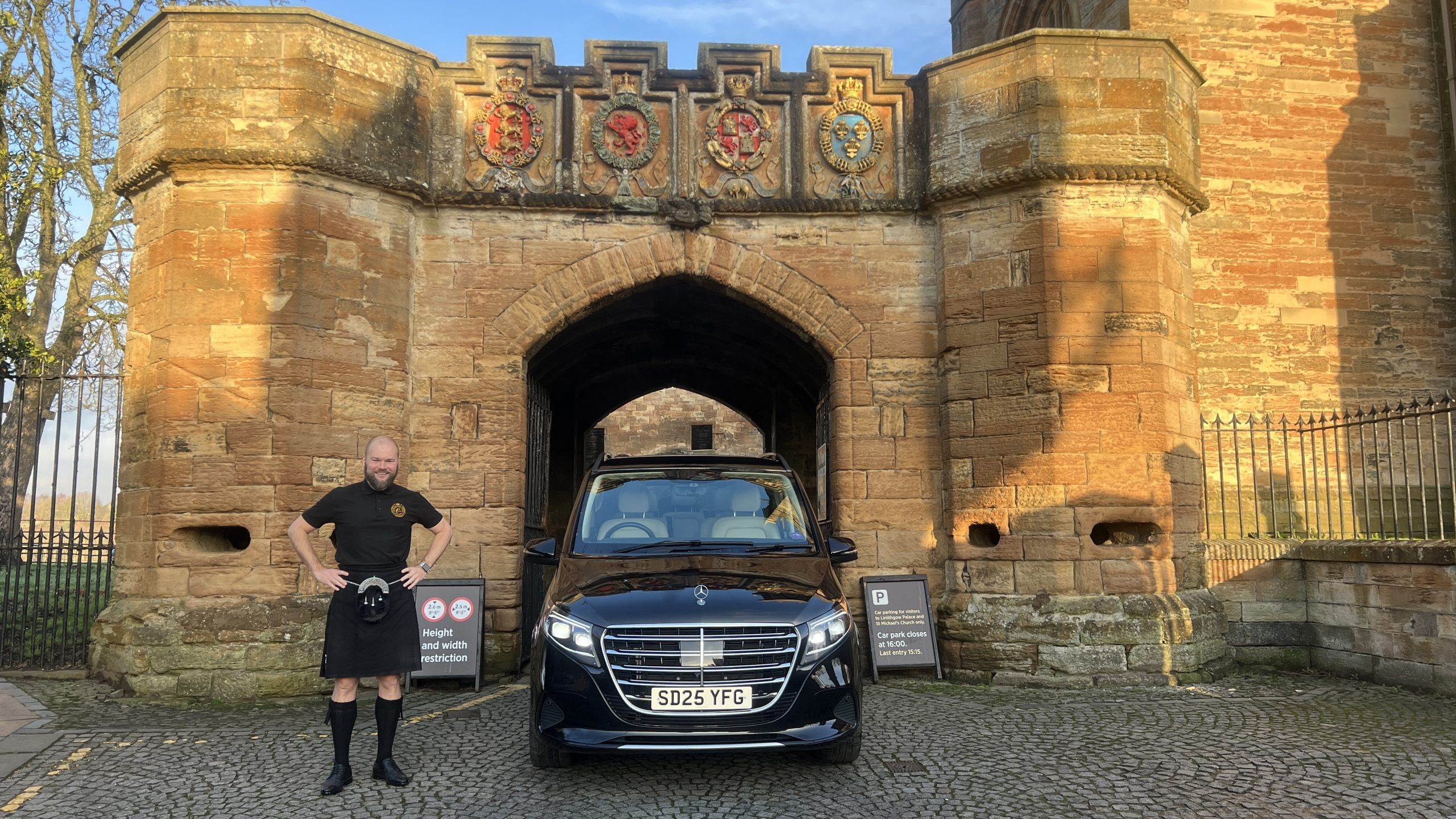 Alexander at Linlithgow Palace with a tour van